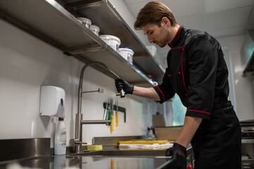 Male culinary chef working in restaurant workspace