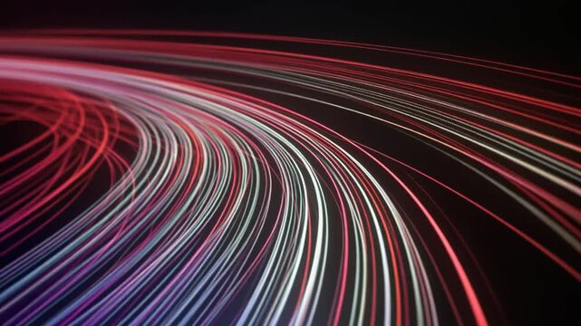 Long exposure shot of colorful light trails curving against a dark background with a dynamic and futuristic mood.