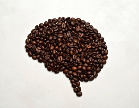 Coffee beans arranged to form a human brain symbolizing alertness and mental stimulation and