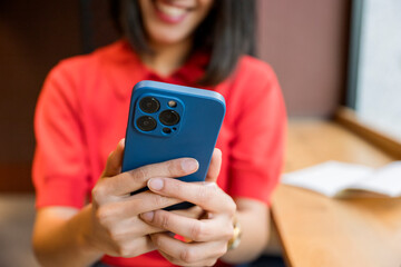 Woman smiling while browsing content on mobile phone