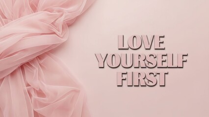 Love yourself first text with pink fabric on a light pink background for self care and motivation