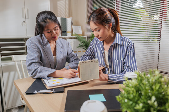 Young women business team work together online, people learn, home office setup for planning strategy, coworkers discuss project milestones, reviewing calendar, making important notes