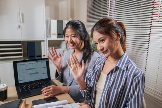 Young women work online home office, business people team learn, collaborate, greeting during video call, showing friendly faces, working on laptop with documents for efficient project completion