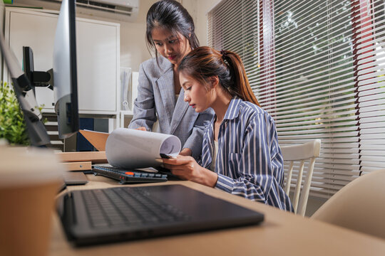 Young business women work online from home office, team people collaborating, reviewing important documents, planning future growth for successful company via computer - Powered by Adobe