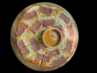 Bacon pizza on a thin pizza crust with thick cheese and sprinkled with oregano on a wooden tray.
