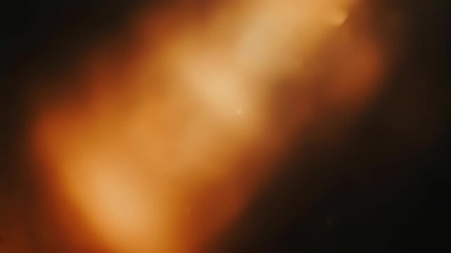 Soft, diffused orange light streaks across dark background