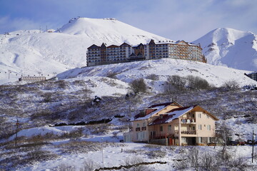 A snow-covered mountain range in the Caucasus region near the Gudauri ski resort. Georgia. Snow-capped mountain peaks and steep slopes.