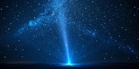 Mystical blue starry night sky with radiant light beam upward