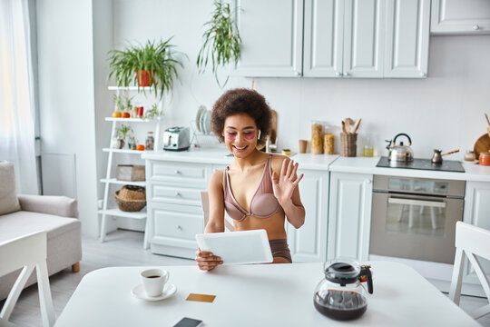 Cozy moments spent in a bright home with a young woman enjoying her tablet - Powered by Adobe