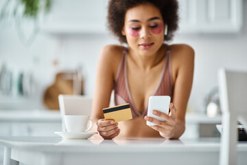 Beautiful woman enjoys a cozy moment at home while shopping online