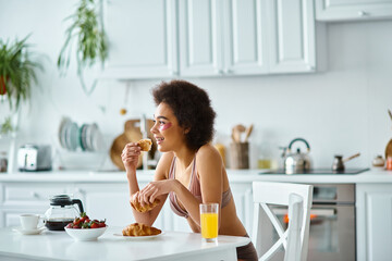 Young woman enjoys a cozy breakfast in her bright home kitchen filled with warmth and flavor