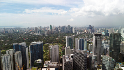 Obraz premium Aerial panorama of Bonifacio Global City business district in Taguig with skyline view of Makati City, Metro Manila, Philippines