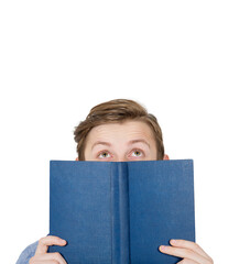 Curious student teenager hiding behind an open books, eyes visible looking up dreaming and imagining. Bookworm guy portrait isolated on transparent background with copy space above head