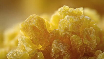 Crystals of Sulphur close-up under soft yellow light