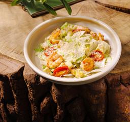 Fresh shrimp salad served in a cozy outdoor setting with wood accents