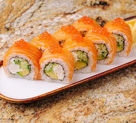 Colorful sushi rolls arranged neatly on a plate ready to be enjoyed