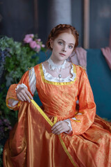 A red-haired girl in a medieval outfit at a ball in a castle interior