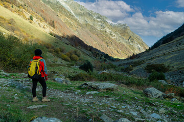 Person is standing in the middle of a field with a backpack on