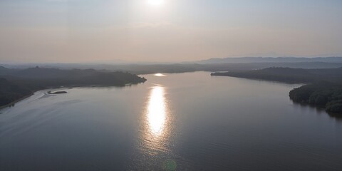Fototapeta premium Vibrant modern orange velvet chair against natural wooden background, suitable for interior decor display