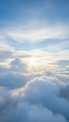 Fluffy cloudscape at sunrise with soft sunlight and blue sky creating serene glowing atmosphere, airy horizon and layered cumulus bank offering peaceful, uplifting mood