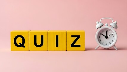 Yellow blocks spelling QUIZ next to a white alarm clock quiz game
