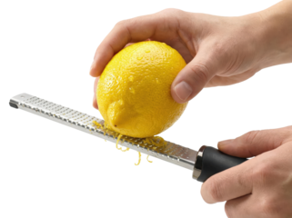Hands grating fresh yellow lemon zest with stainless steel grater tool