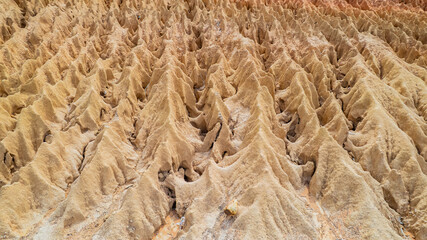 A ridge of land that has been naturally eroded by water