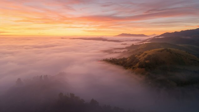 Morning landscape with foggy hills illuminated by sunrise, emphasizing natural beauty during dawn