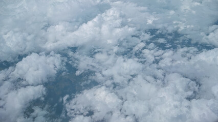 Fluffy cumulus clouds in clear blue sky