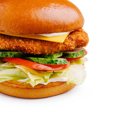 Crispy chicken sandwich with fresh vegetables and cheese on a toasted bun