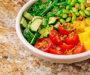 Fresh and colorful salad bowl with vegetables and fruits for healthy eating