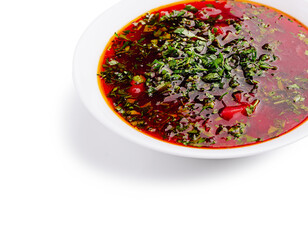 Delicious tomato soup with herbs and spices on a white plate