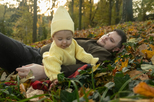 Joyful Baby Playing Outdoors in Autumn Happy fatherhood
