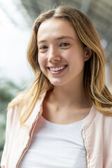 Close-up of smiling young woman with natural beauty and casual style