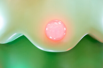 Red bauble on plastic Christmas tree