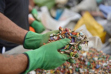 Recyclable Metal Scrap in Hands Wearing Gloves - Recycling Concept