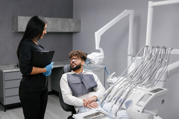 Dentist consulting patient about dental health in clinic