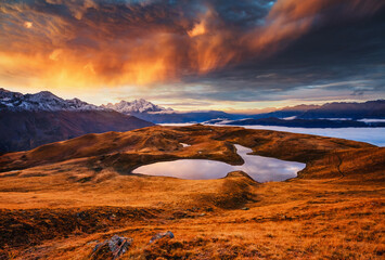 Stunning sunset over Koruldi lakes at the foot of Ushba amidst majestic cliffs. Location place Upper Svaneti, Mestia, Georgia. High Caucasus ridge. Photo wallpapers. Discovery the beauty of earth.