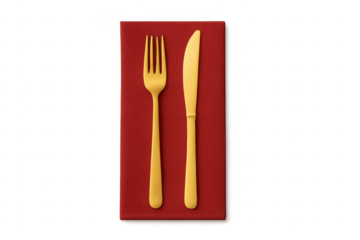 Gold fork and knife on red napkin dining table setting