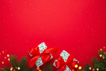 Merry Christmas and Happy Holidays greeting card, frame, border. New Year. Red Christmas ornaments and gifts, presents on red background top view. Xmas holiday festive theme. Christmas decoration