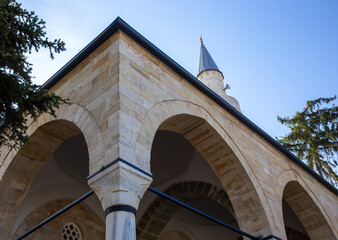 Ottoman mosque arches and minaret under clear sky Tarakli Sakarya