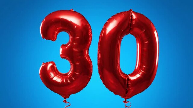 Red foil balloons forming the number 30 against a blue background. Celebration for a 30th birthday or anniversary. Sale and discount concept