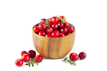 Cranberries in a wooden bowl isolated on a white background.