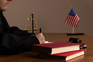 The judge is presiding over a court session, holding a gavel in his hand.
