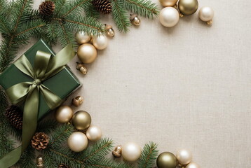 Christmas or New Year fir frame decorations gold colors on beige background with empty copy space for text. holiday and celebration concept for postcard or invitation. top view . Aesthetic minimalist 