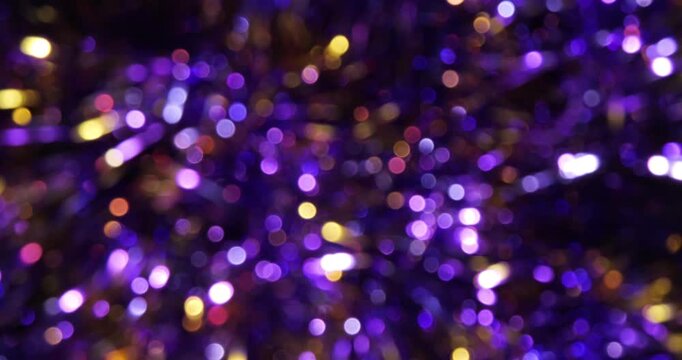 Rotating christmas purple garland decoration with bokeh effect. Great for Christmas, New Year, and celebration themes.