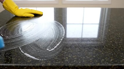 Thorough Cleaning Process of a Granite Kitchen Countertop Using a Sponge and