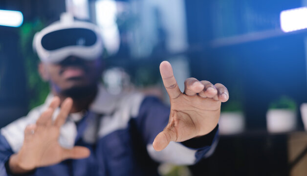 African male industrial engineer engaged in virtual reality experience using vr headset