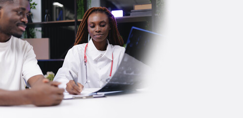 African female doctor analyzing x-ray with patient in modern medical office, banner with copy space