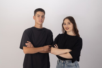  Young man and woman standing side by side with relaxed,